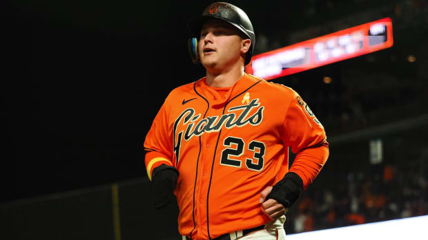 Giants outfielder Joc Pederson runs to the dugout after batting during a game.